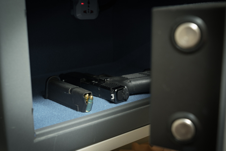 Gun and ammo magazine in the safe, front view