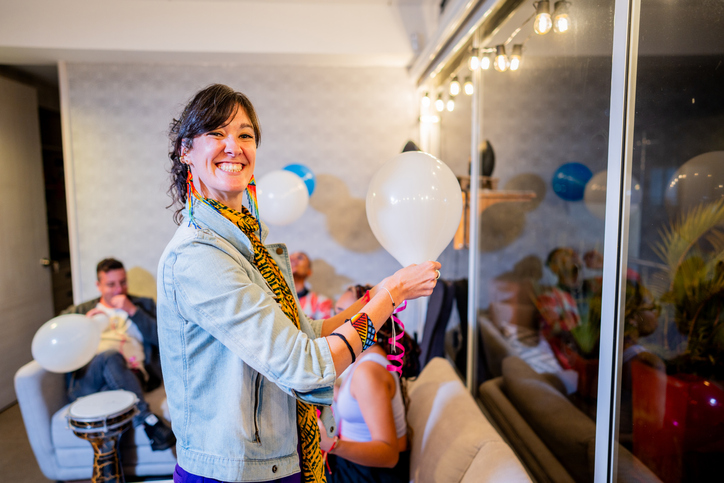 Portrait of a mid adult woman decorating living room to a party at home