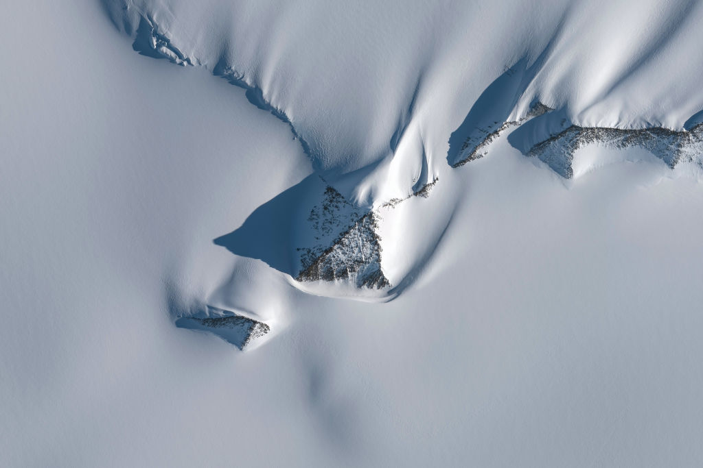 ANTARCTICA - JANUARY 19, 2019: DigitalGlobe satellite imagery of a pyramid-like mountain within the Heritage Mountain Range in Antarctica. Image-1.