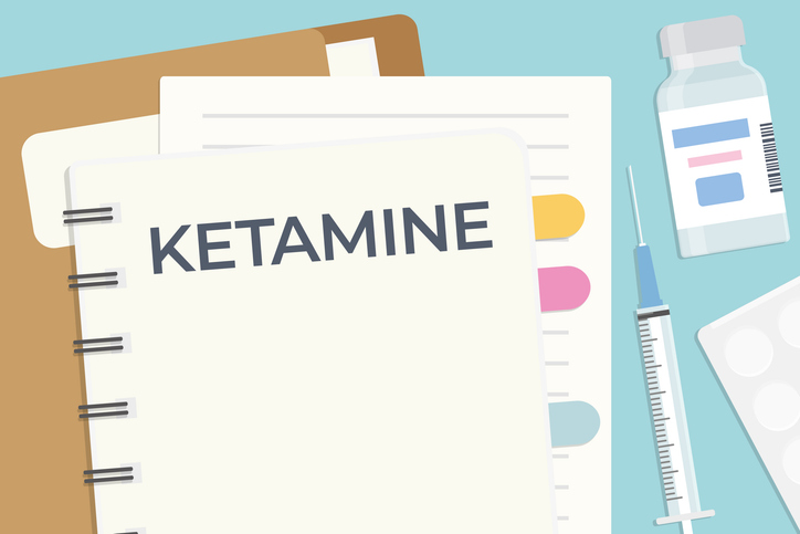 ketamine word written on the spiral notebook, flat lay composition on the doctor desk