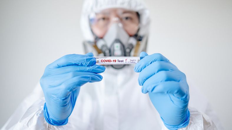 Medical scientist holding COVID-19 Test tube