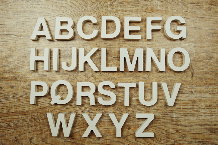 English alphabet capital letters top view on wooden background