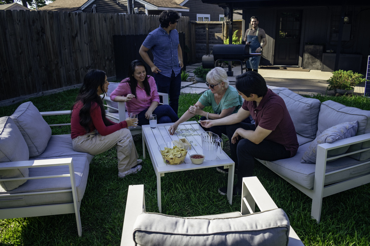 Family plays dominos during family barbecue
