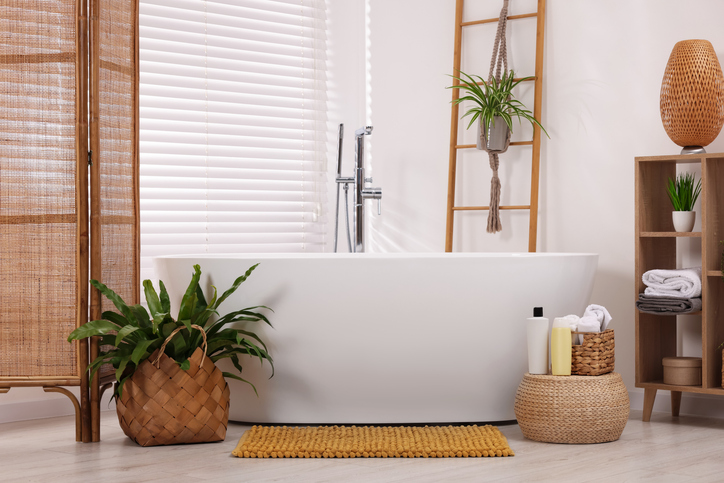 Stylish bathroom interior with soft bath mat and tub