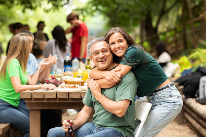 Happy family gathering with laughter and joy in a park during summer