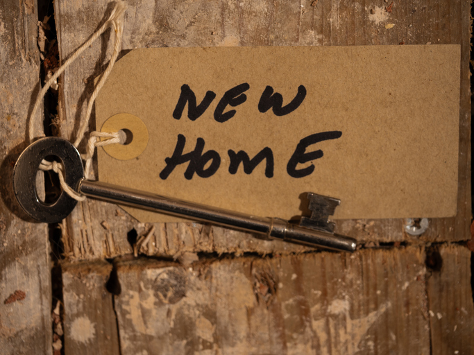 Key to new home on dusty distressed wooden floorboards