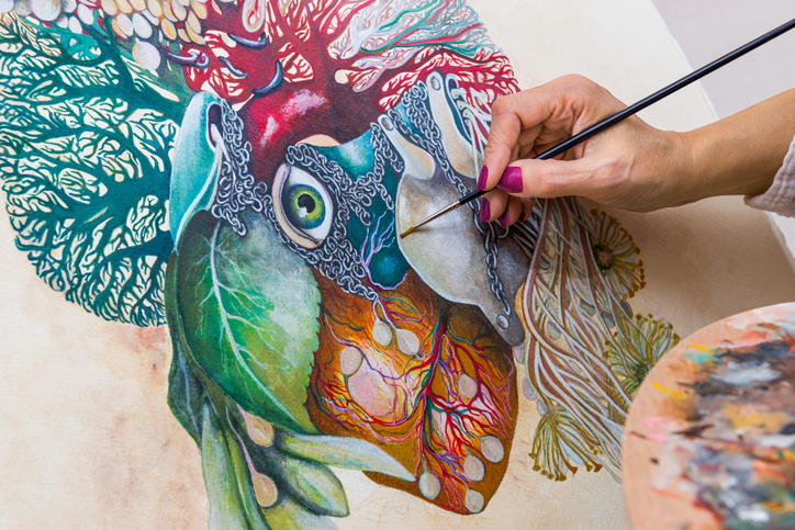 Artist illustrator painting on paper