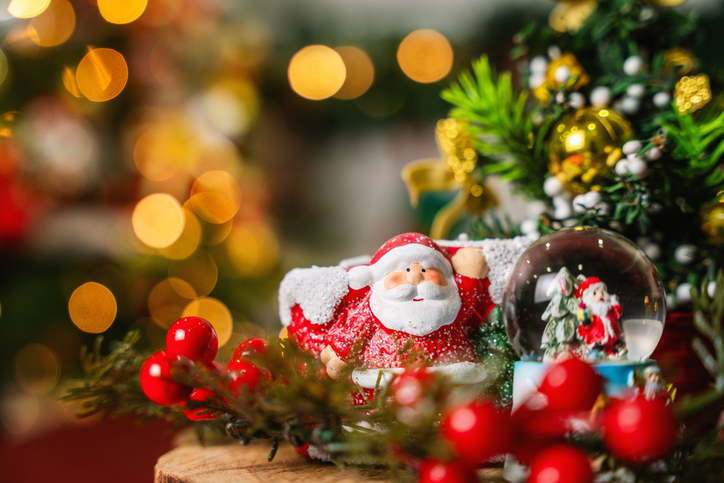 Festive Christmas Scene with Santa Claus Figurine and Snow Globe