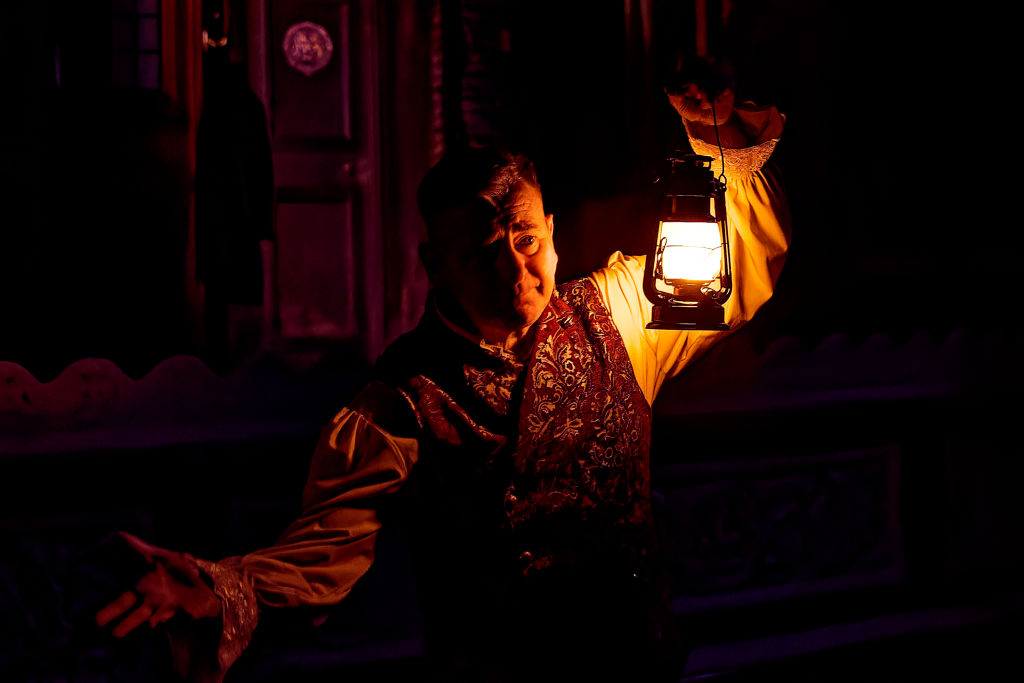 An actor is seen performing in the play "A Christmas Carol...