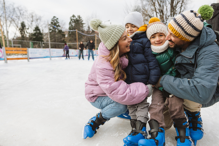 Happy family enjoying ice skate