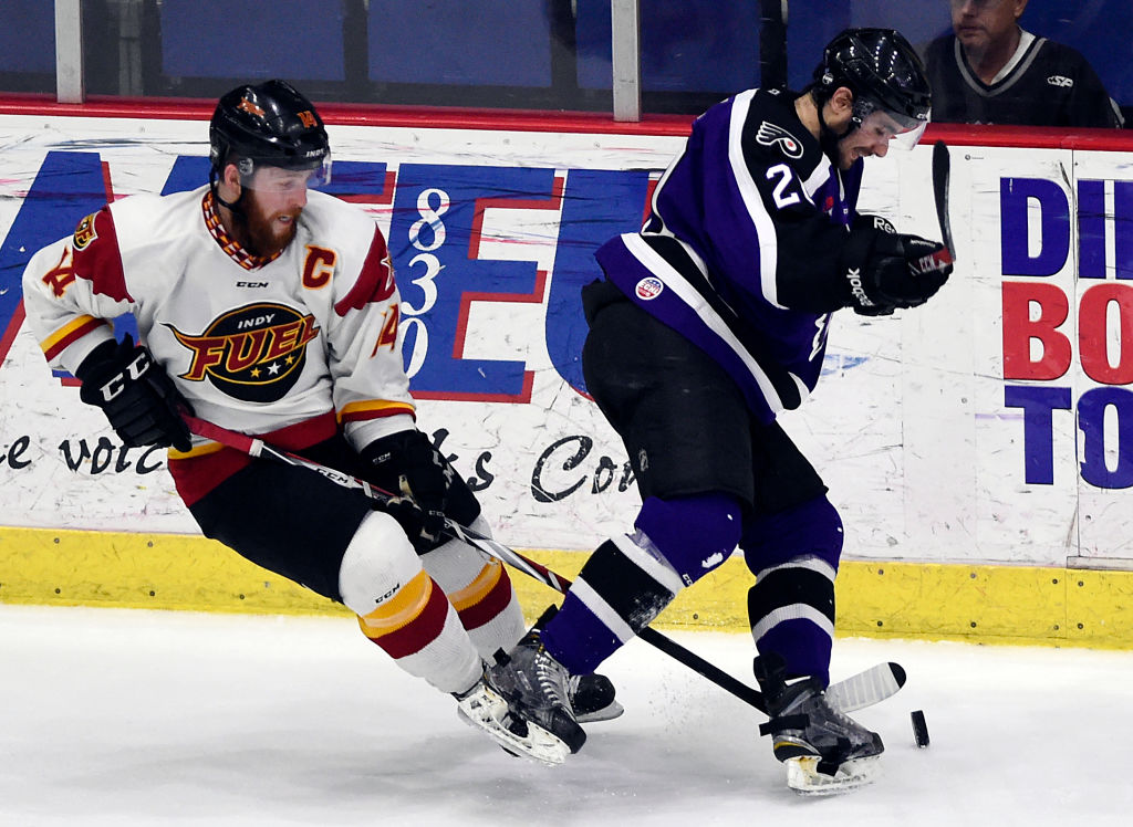 Reading's Brett Flemming (20) is tripped up by Indy's Mike Duco (14).Reading Royals lose 3-2 to the Indy Fuel in a minor league ECHL hockey game at Santander Arena, Reading. Photo by Jeremy Drey 4/10/2015