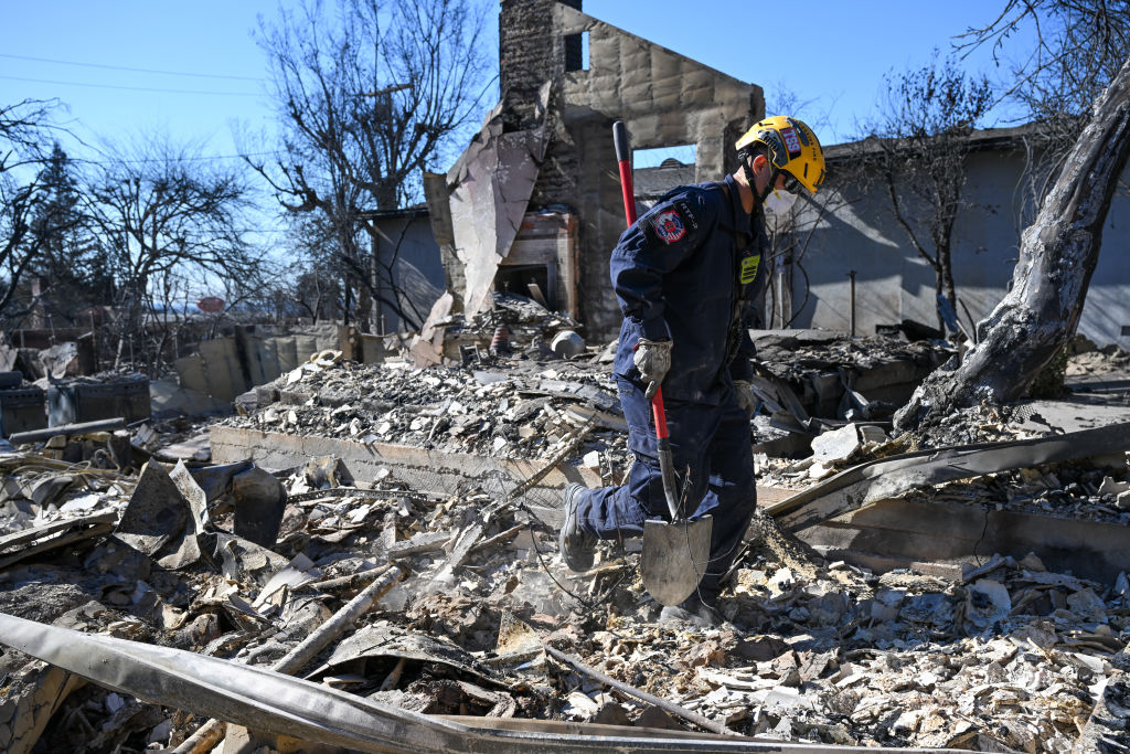 Los Angeles Fire: Search and Rescue team look for human remains in ashes of burned houses