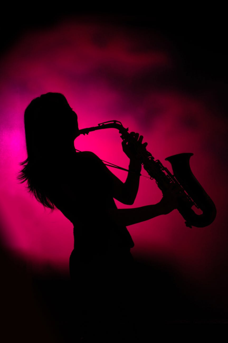 silhouette of woman playing saxophone