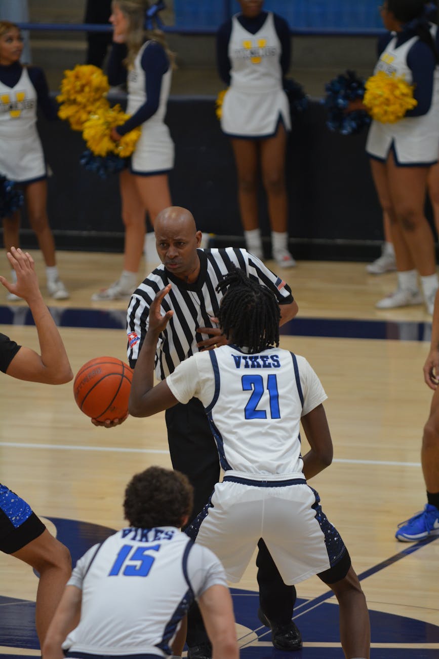 high school basketball game tip off action