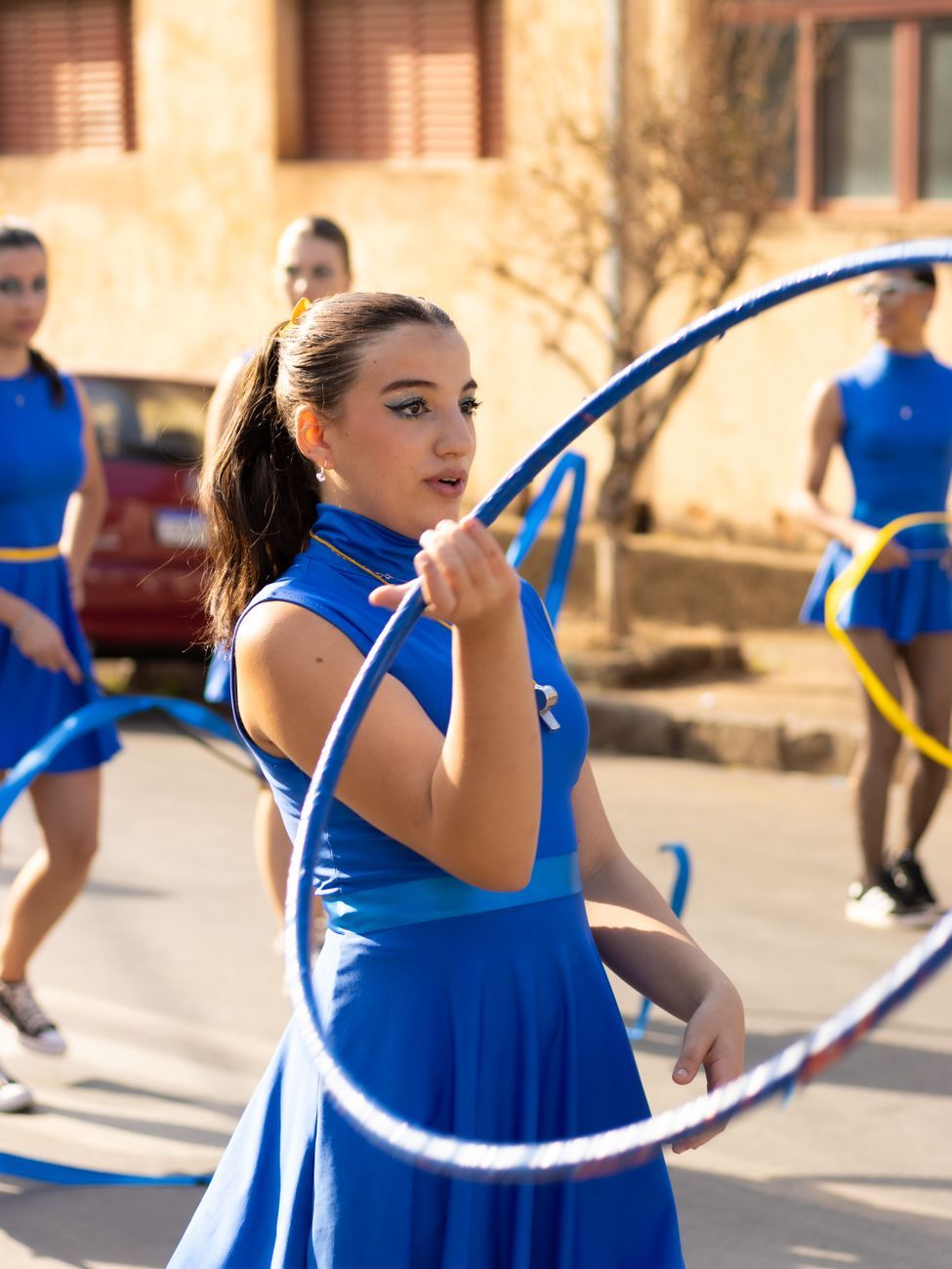 group of women performing hula hoop dance outdoors