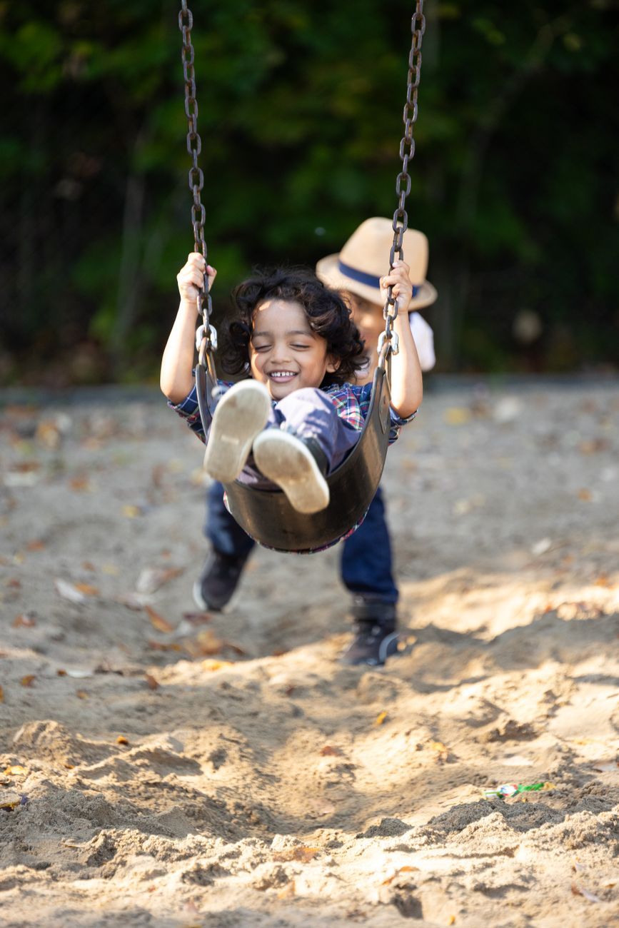 joyful kids playing on swings outdoors